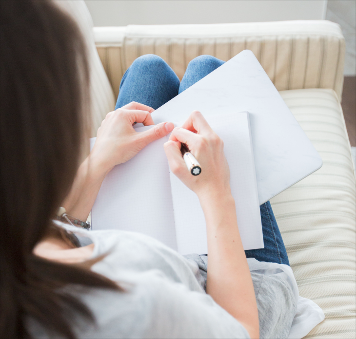 Person writing in a book