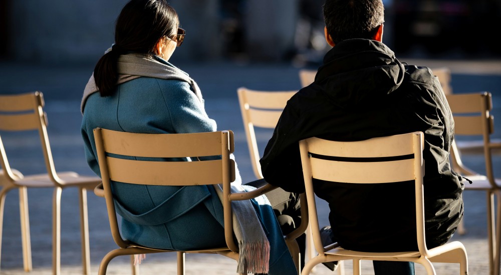 two people sitting and talking