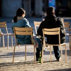 two people sitting and talking