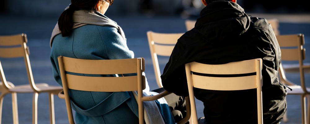 two people sitting and talking