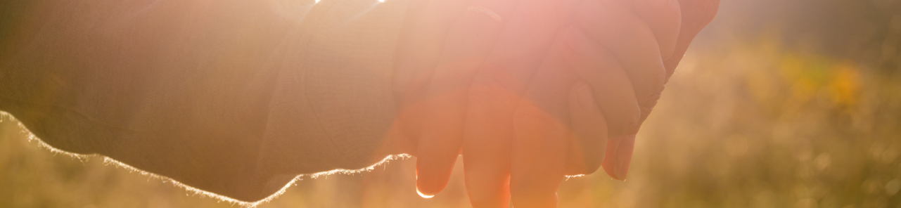 Child holding caregiver's hand